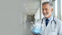 Mature male doctor with stethoscope holding glowing digital tablet with medical icons in modern hospital corridor, representing healthcare technology innovation.