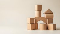 Natural wooden building blocks arranged in creative tower structure on neutral background for educational play and development activities.