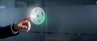 Businessman hand holding glowing digital fingerprint icon with neon green and white light effect against blurred office background for biometric security and identity verification concepts.