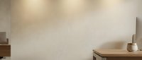 Minimalist modern interior with warm beige textured wall, wooden furniture and ceramic vase creating serene atmospheric lighting for contemporary home design.