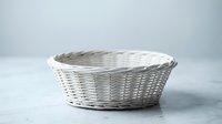 Empty white wicker basket on clean surface for storage organization and home decor applications in modern interior design projects.
