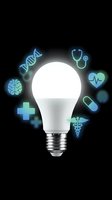 Glowing light bulb surrounded by medical icons including DNA, brain, stethoscope, and caduceus on dark background, symbolizing healthcare innovation.