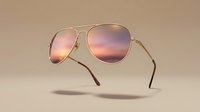 Stylish gold aviator sunglasses with mirrored sunset-toned lenses floating on a warm beige background, casting a soft shadow.