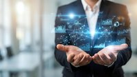 Professional businessman holding holographic data analytics network with charts, graphs and digital connections floating above hands in modern office.