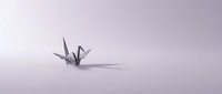 Origami paper crane on soft purple gradient background, minimalist composition with shadow, suitable for wellness, meditation, peace, and zen-themed designs.