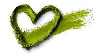 Heart shape drawn with green matcha powder on white background, symbolizing love for healthy lifestyle and natural ingredients.