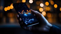 Glowing smartphone screen showing constellation pattern held in dark with blurred bokeh lights background, creating magical starry night atmosphere.