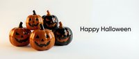 Group of carved jack-o-lantern pumpkins with glowing faces arranged together on white background for seasonal holiday decorations and festive designs.