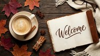 Autumn flat lay with coffee cup, open book with Welcome lettering, cinnamon, anise, glasses, scarf, and fall leaves on wooden table.
