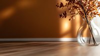Elegant glass vase with dried brown flowers casting shadows on warm copper background, minimalist home decor composition in modern interior design style.