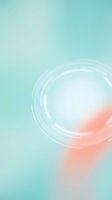 Soft glowing orb with concentric rings on turquoise and coral gradient background, ideal for wellness, skincare, cosmetics, and modern design projects.