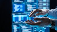 Gloved hands of a male IT specialist interacting with glowing blue data screens in a dark server room, technology concept.