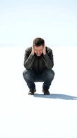 Stressed Caucasian man in military jacket crouching with hands covering ears showing mental health struggle and emotional pain on white background.