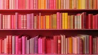 Colorful bookshelf with neatly arranged books in gradient shades of pink, red, orange, and yellow creating a vibrant rainbow effect.