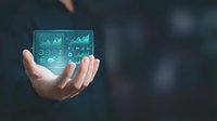 Business professional displaying holographic financial data analytics dashboard with charts and graphs floating above open palm for presentations.