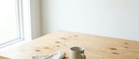 Wooden table with coffee cup and newspaper near bright window, isolated on white background, ready for design use on websites, blogs, and marketing materials.