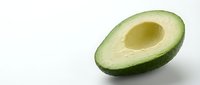 Halved avocado with pit removed, isolated on white background, ready for food and nutrition design projects.