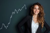 Young Caucasian businesswoman with long wavy hair wearing black blazer and white shirt smiling confidently next to rising stock market chart on dark background.