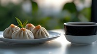 Asian steamed dumplings with mint garnish served on white ceramic plate next to traditional black and white tea bowl in natural morning light setting.