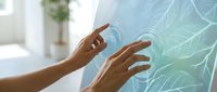 Hands interacting with futuristic holographic interface displaying glowing network connections in modern office environment for technology presentations.