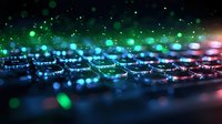Glowing gaming keyboard with colorful RGB backlight illumination in dark room, macro shot with bokeh effect and light reflections creating atmospheric mood.