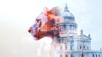 Double exposure of majestic lion profile merged with historic domed government building, symbolizing strength and authority in leadership.