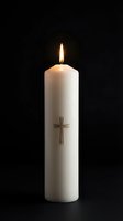 White pillar candle with cross symbol burning against black background for religious ceremonies, memorial services, and spiritual worship.