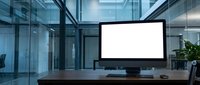 Modern office workspace with blank computer monitor screen on wooden desk in contemporary glass building interior for business presentations and digital mockups.