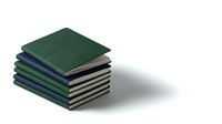Stack of green and navy hardcover notebooks on white background, minimalist stationery for office, education, and planning concepts.