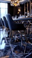 Luxurious restaurant interior with modern navy chairs, black marble flooring, and crystal chandelier. Elegant dining setup with wine glasses and ambient lighting creates upscale atmosphere.