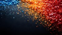Vibrant glitter particles scattered on dark background in blue, orange and red gradient colors create magical festive sparkle effect for holiday designs.