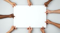 Multiple diverse hands holding blank white poster with copy space, representing teamwork, collaboration, unity and community support from different ethnicities and backgrounds.