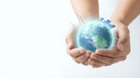 Two hands holding a glowing digital globe with network connections, representing global connectivity, environmental care, and sustainable business solutions for worldwide communication.