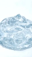 Clear gel or liquid cosmetic product with bubbles and droplets isolated on white background, suitable for skincare, beauty, and cosmetics packaging design.