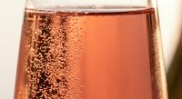 Sparkling rosé champagne with elegant bubbles in crystal glass, perfect for celebrations, weddings, romantic dinners and luxury events.