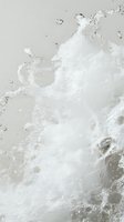 Dynamic white foam and bubbles swirling in liquid creating abstract patterns against light gray background, macro photography capturing fluid motion and texture.