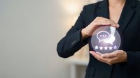 Professional woman in dark blazer holding glowing crystal ball with chat and star icons, representing customer feedback, service quality rating, and communication concept.