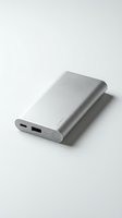 Sleek silver portable power bank with USB and charging ports, featuring LED indicator lights, isolated on white background for tech product design use.