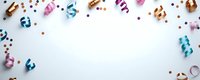 Festive party border with colorful curled ribbons and metallic confetti scattered on white background, copy space for celebration message or design.