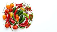 Assorted fresh chili peppers and bell peppers arranged on white background, isolated for culinary, cooking, and food design projects.