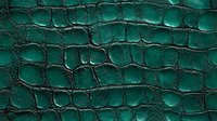 Emerald green crocodile leather texture with deep embossed pattern showing luxurious scales and natural reptilian surface structure for fashion design background.