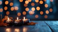 Festive candles burning on wooden surface with warm bokeh lights creating cozy holiday atmosphere for seasonal celebrations and home decor.