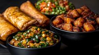 Traditional Middle Eastern feast with roasted potatoes, lentil salad, fresh herbs and golden pastries on dark background for restaurant menu design.
