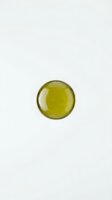 Golden olive oil in glass bowl isolated on white background for culinary and cooking design projects.