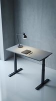 Modern minimalist office desk with adjustable height black legs and desk lamp in contemporary workspace with concrete walls for productivity.