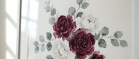 Elegant burgundy and white roses with eucalyptus leaves arrangement on neutral background. Romantic floral composition for wedding invitations and decor.