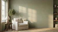 Cozy modern living room interior with white armchair, olive tree plant, wooden side table and natural sunlight shadows on green wall for home decor inspiration.