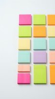 Colorful sticky notes arranged in grid pattern on white background, featuring pink, lime green, yellow, orange, peach and mint tones for office organization and planning projects.
