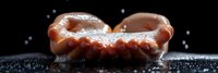 Grilled bratwurst sausage with water droplets on dark surface. Fresh cooked meat product for barbecue, cooking and food preparation concepts.