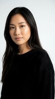 Young Asian woman in black sweater portrait on white background isolated for professional headshot and business marketing materials.